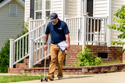 inspector surveying home porch