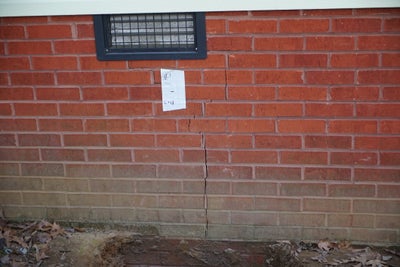 Crack through exterior bricks at home.