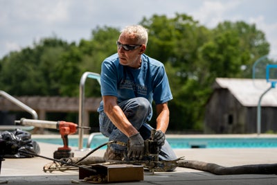 crew member installing polyrenewal concrete lifting on pool deck