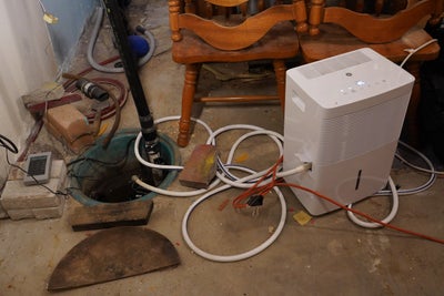 dehumidifier and sump pump in basement