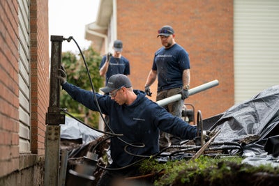Groundworks crew installing foundation piers.