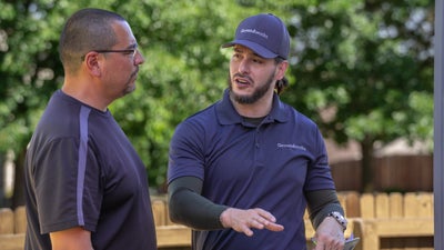 Groundworks employee talking with a homeowner