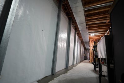 vapor barrier and braces installed on basement wall