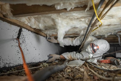 crew wearing proper protective equipment while working in a crawl space