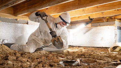 A Foundation Recovery Systems technician working in a crawl space.