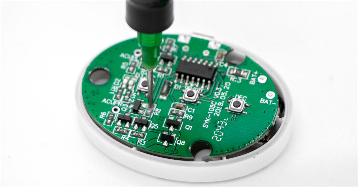 A Dymax light-curable encapsulant is applied to a electronic wearables printed circuit board.