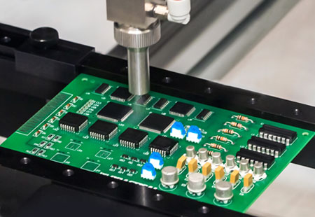 Dymax conformal coating is sprayed onto a printed circuit board.