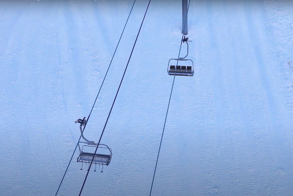 overhead view of chairlift on snowy slope