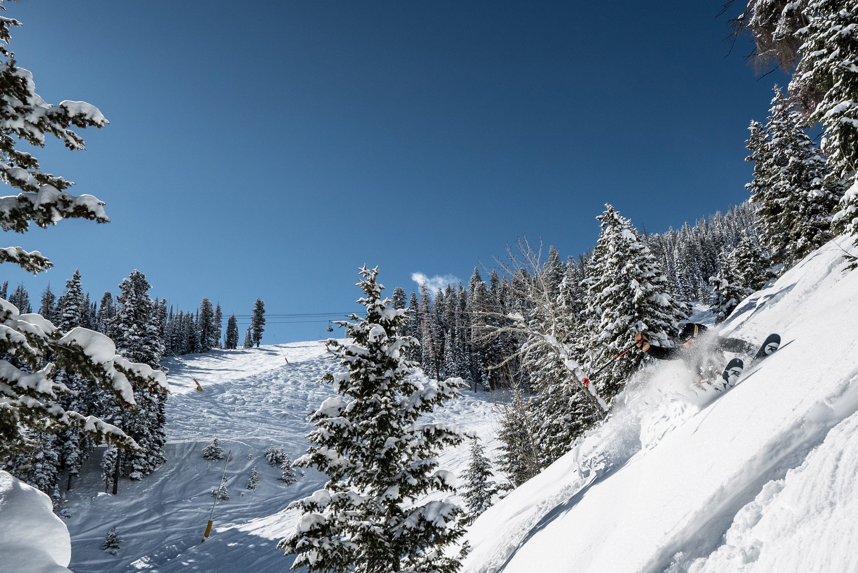 skier on steep snowy slope