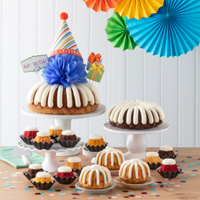 Birthday Celebration Bundt Cakes with a birthday cone on top of a blue bow.