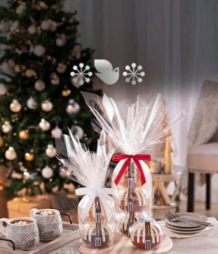 A bundt cake and assorted bundtlets and bundtinis on a wooden table.