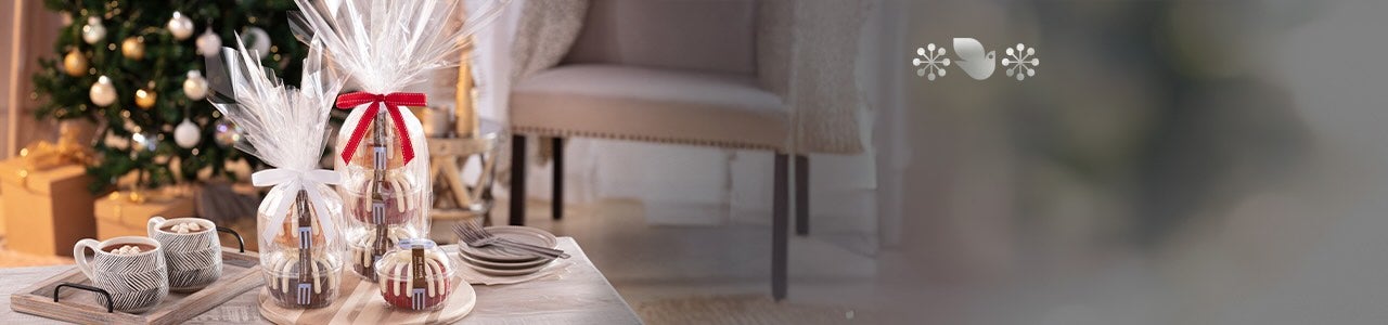 A bundt cake and assorted bundtlets and bundtinis on a wooden table.
