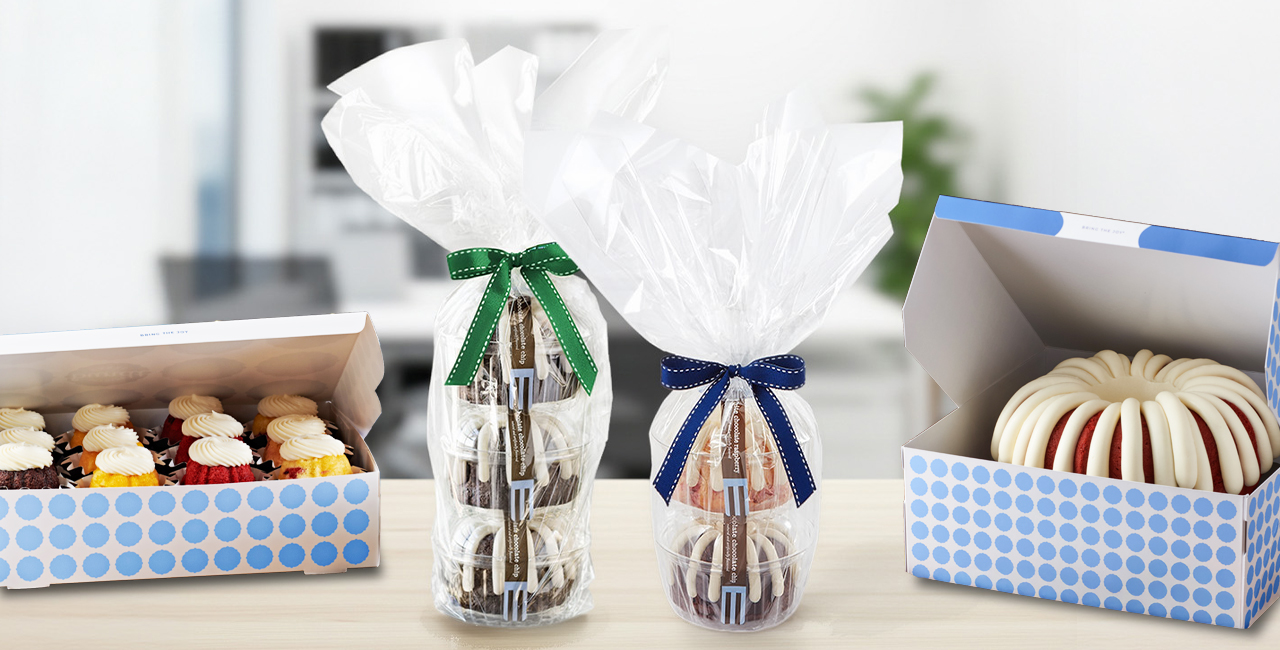 Nothing Bundt Cakes gift packaging featuring assorted mini Bundt cakes, wrapped Bundtini towers with ribbons, and a classic Bundt cake topped with cream cheese frosting in branded bakery boxes.
