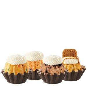 Four Bundtinis sitting in a row. Confetti, Strawberries & Cream, Oreo Cookies & Cream, and Biscoff® Cookie Butter Cake.