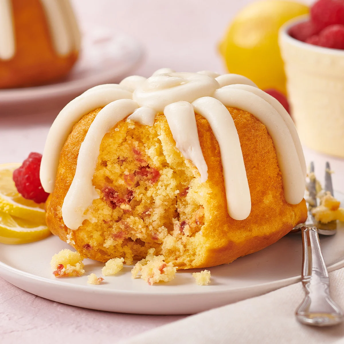 A personal Lemon Raspberry Bundtlet crowned with our signature frosting.