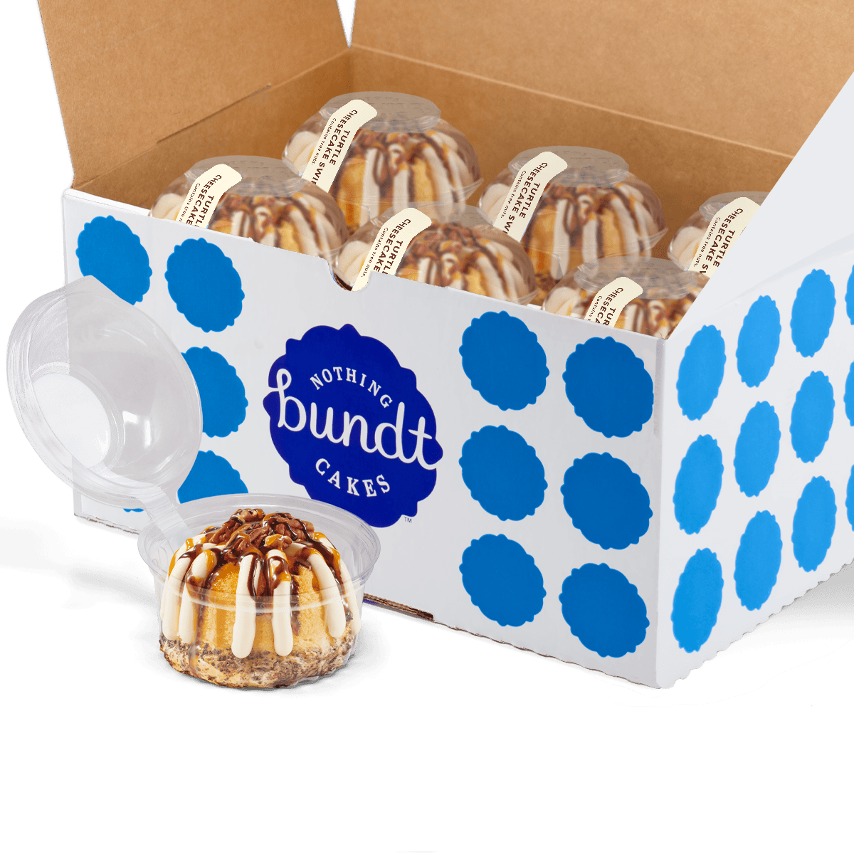 12 individually packaged Turtle Cheesecake Swirl Bundtlet gift wrapped in cellophane with a blue stitched ribbon.
