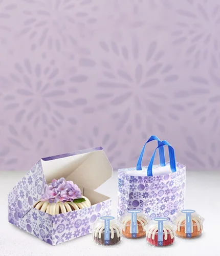 Bundt Cake in a Nothing Bundt Cakes bakery box, Spring Bundtastic Bag, and four Bundtlets.
