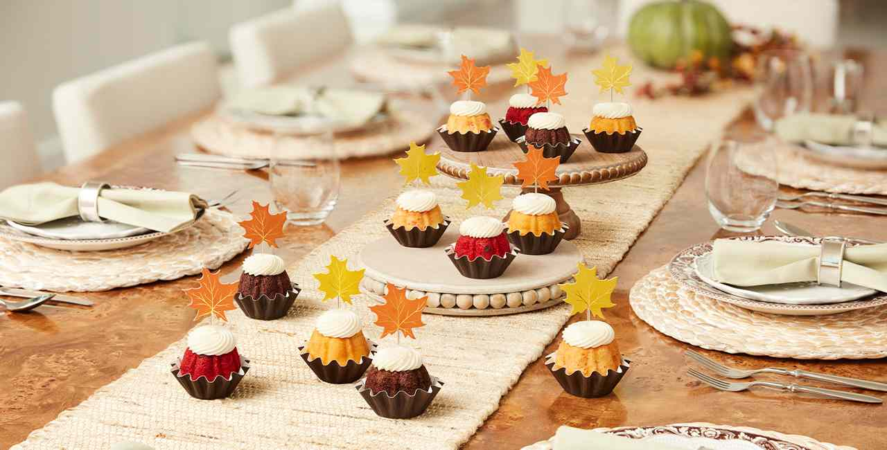 Mini bundt cakes with cream cheese frosting and fall leaves decorations.
