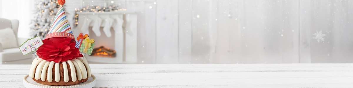 Happy Bundt day Bundt Cake - with a red bow and decorative party hat and paper presents