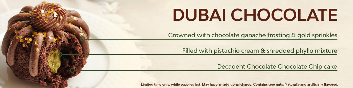 A decadent Chocolate Chocolate Chip cake, filled with pistachio cream & shredded phyllo mixture, crowned with chocolate ganache frosting & gold sprinkles. Available for a limited time only, while supplies last. May have an additional charge. Contains tree nuts. Naturally and artificially flavored.