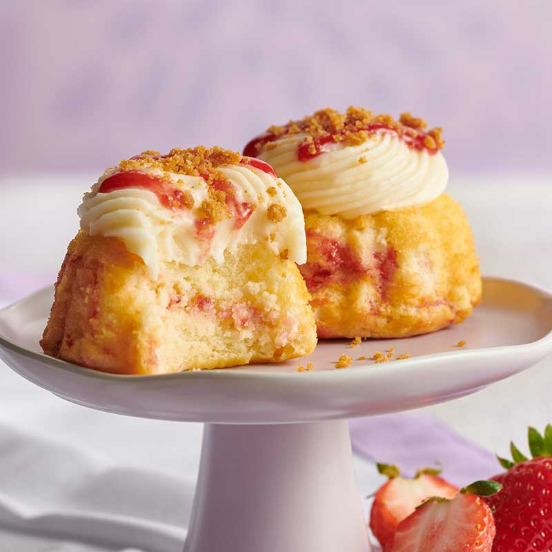 Two Strawberry Cheesecake Swirl Bundtinis crowned with signature frosting - Shop Bundtinis
