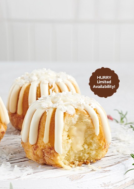 COCONUT CAKE FILLED AND DRIZZLED WITH VANILLA PUDDING, TOPPED WITH COCONUT FLAKES AND WINTER SPRINKLES -- Limited Time