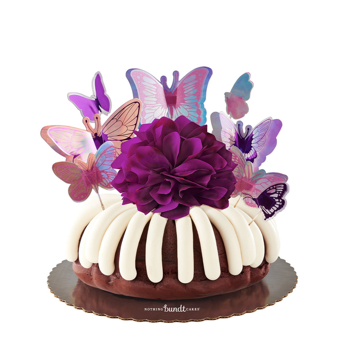Bundt cake topped with cream cheese frosting, butterfly decorations, and a purple bow.