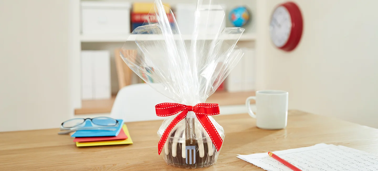 Single Bundtlet Tower gift wrapped in cellophane with decorative ribbons.