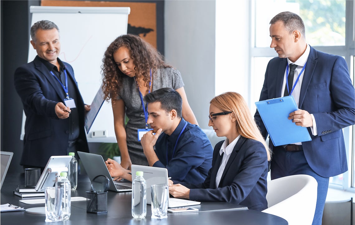 A group of business people holding a meeting in a conference room.
