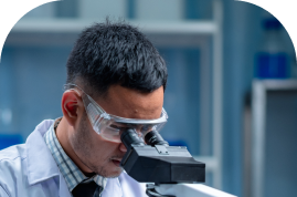 A young scientist looking through a microscope.