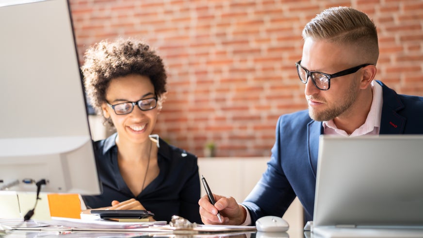 Two people discussing how commercial compliance is a must in pharma’s complex regulatory landscape.