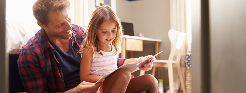 Father reading a story to his little girl