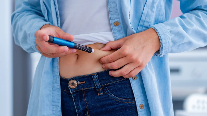 A diabetic patient makes an insulin injection with insulin pen at home.