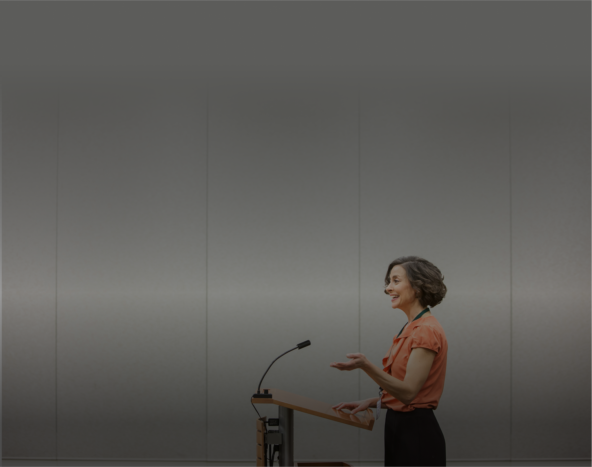 A woman speaking at a business seminar. 