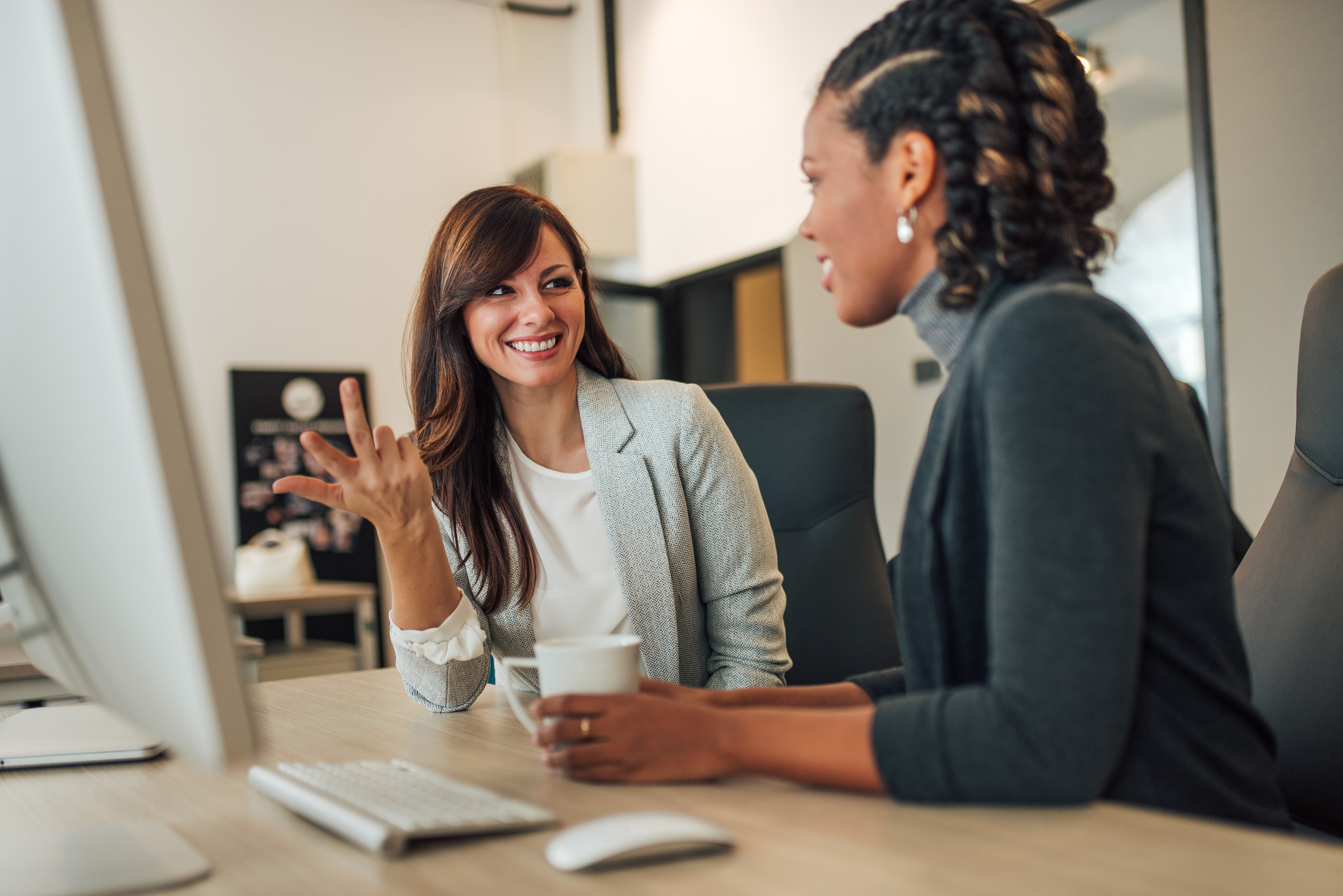 Female colleagues collaborating in office