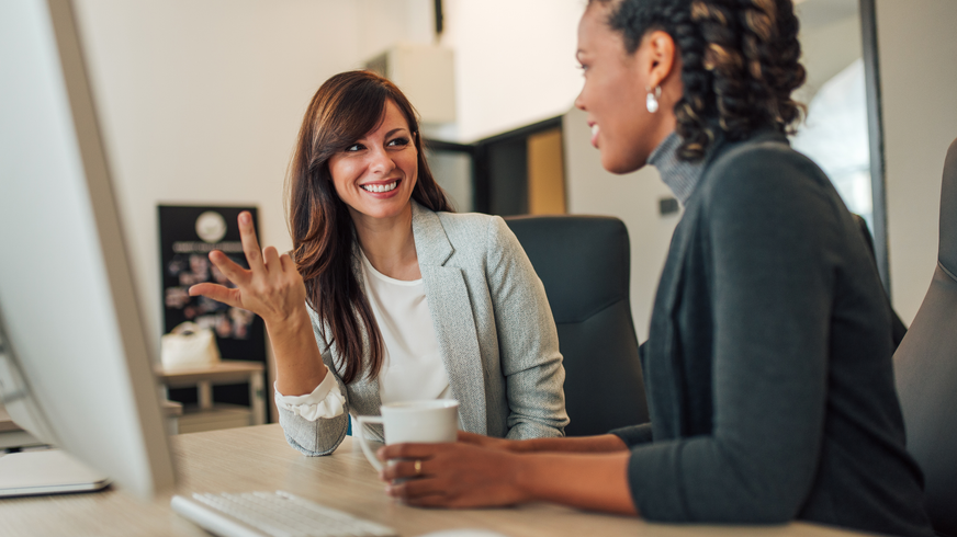 Female colleagues collaborating in office