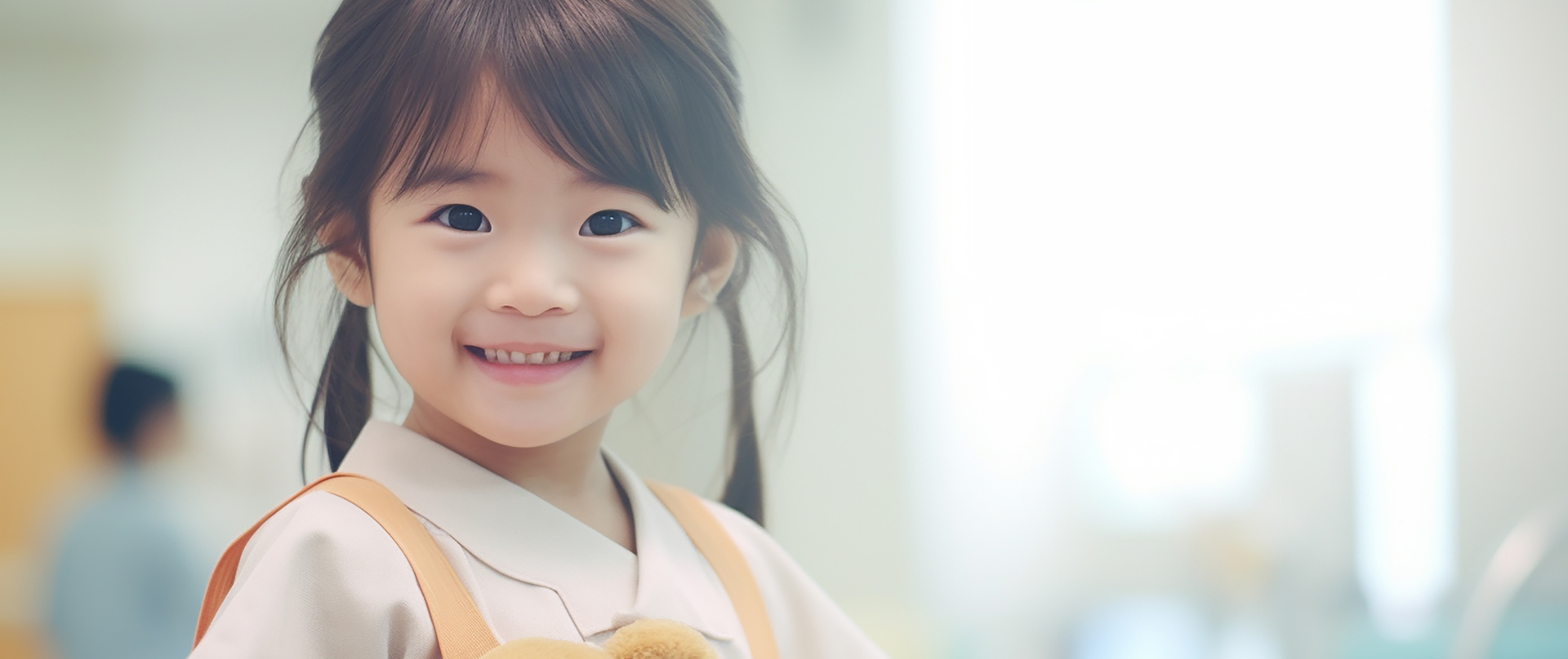 Young girl holding teddy bear