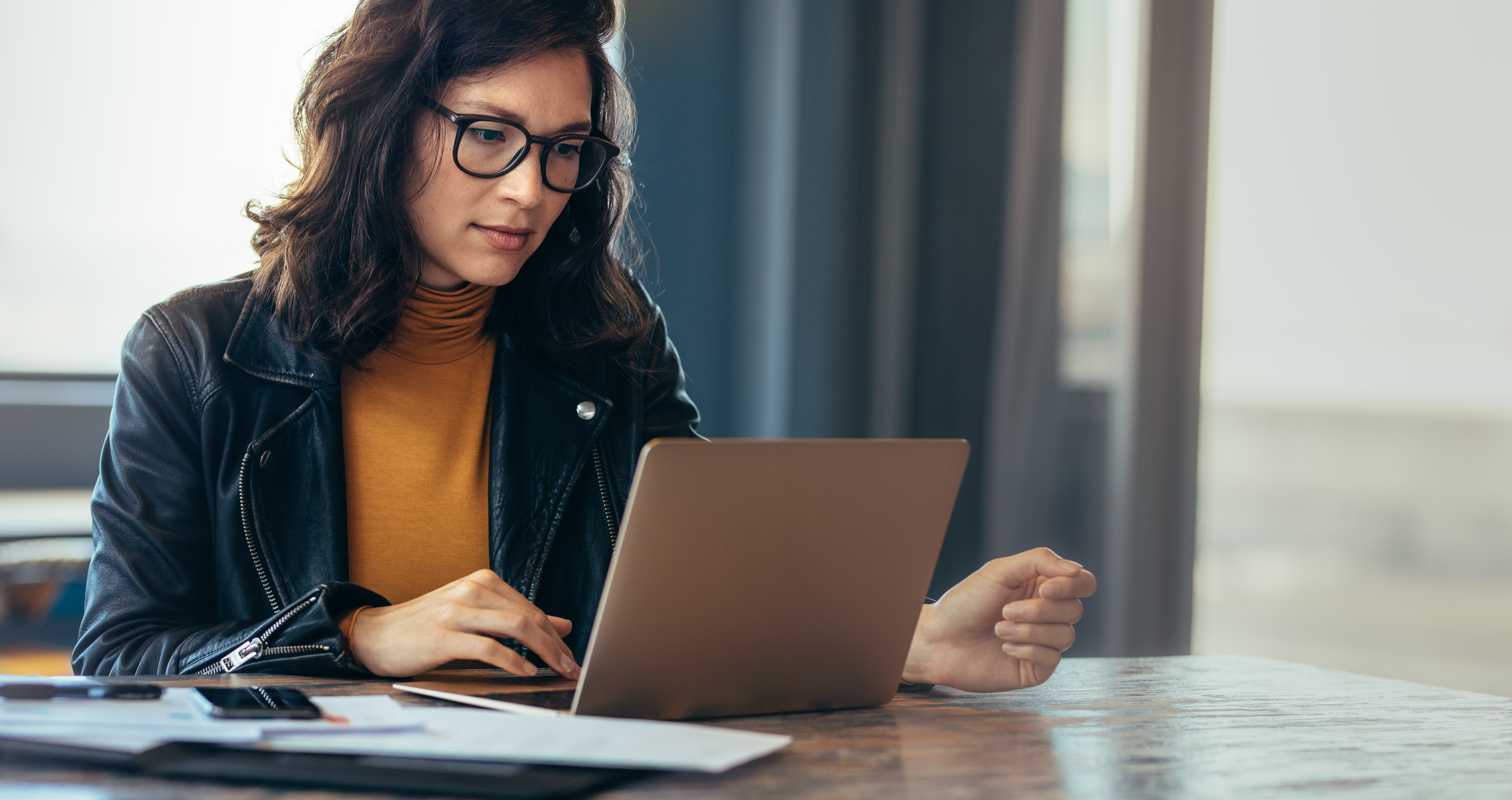 woman sales rep entering info onto her laptop