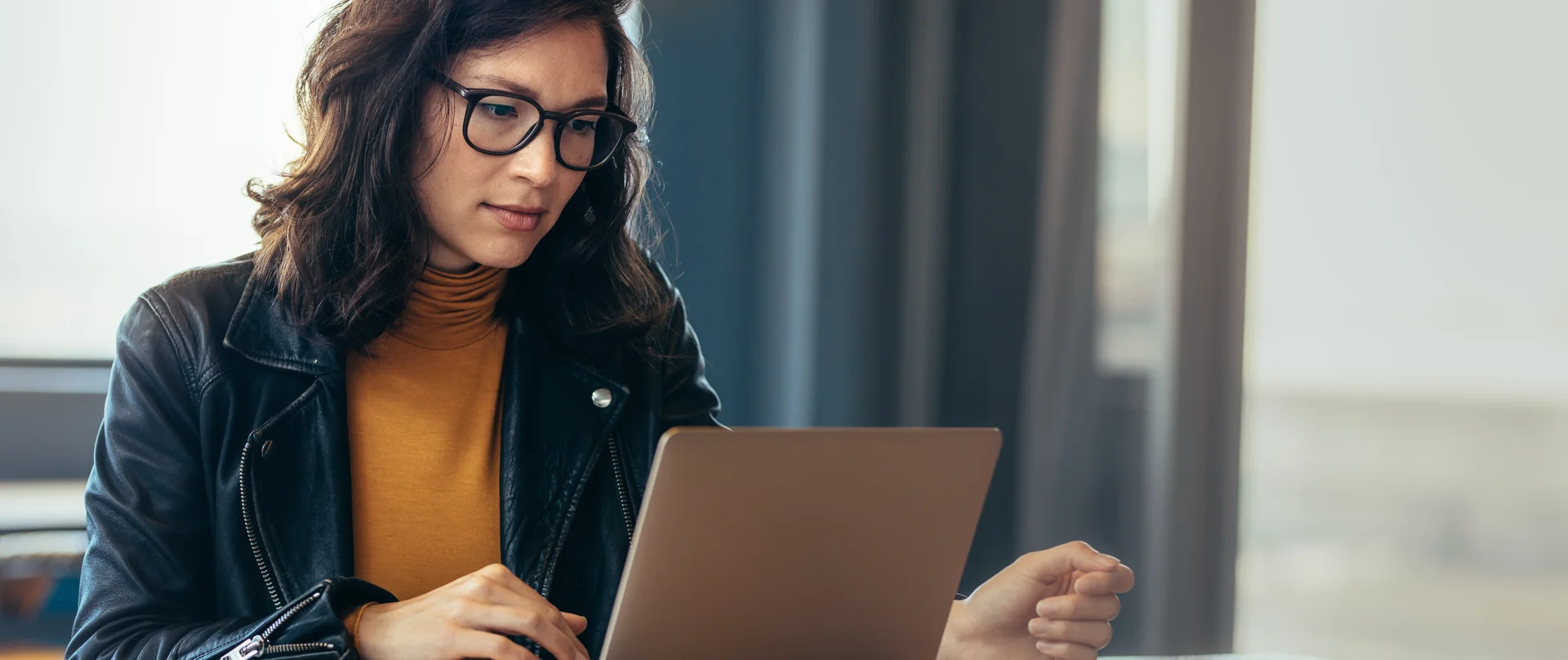 woman sales rep entering info onto her laptop
