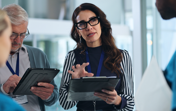 Senior healthcare professional discussing data