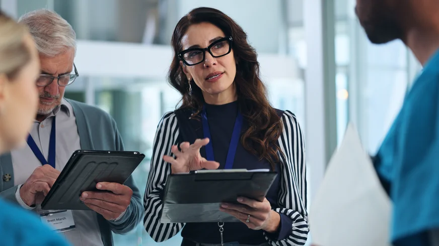 Senior healthcare professional discussing data