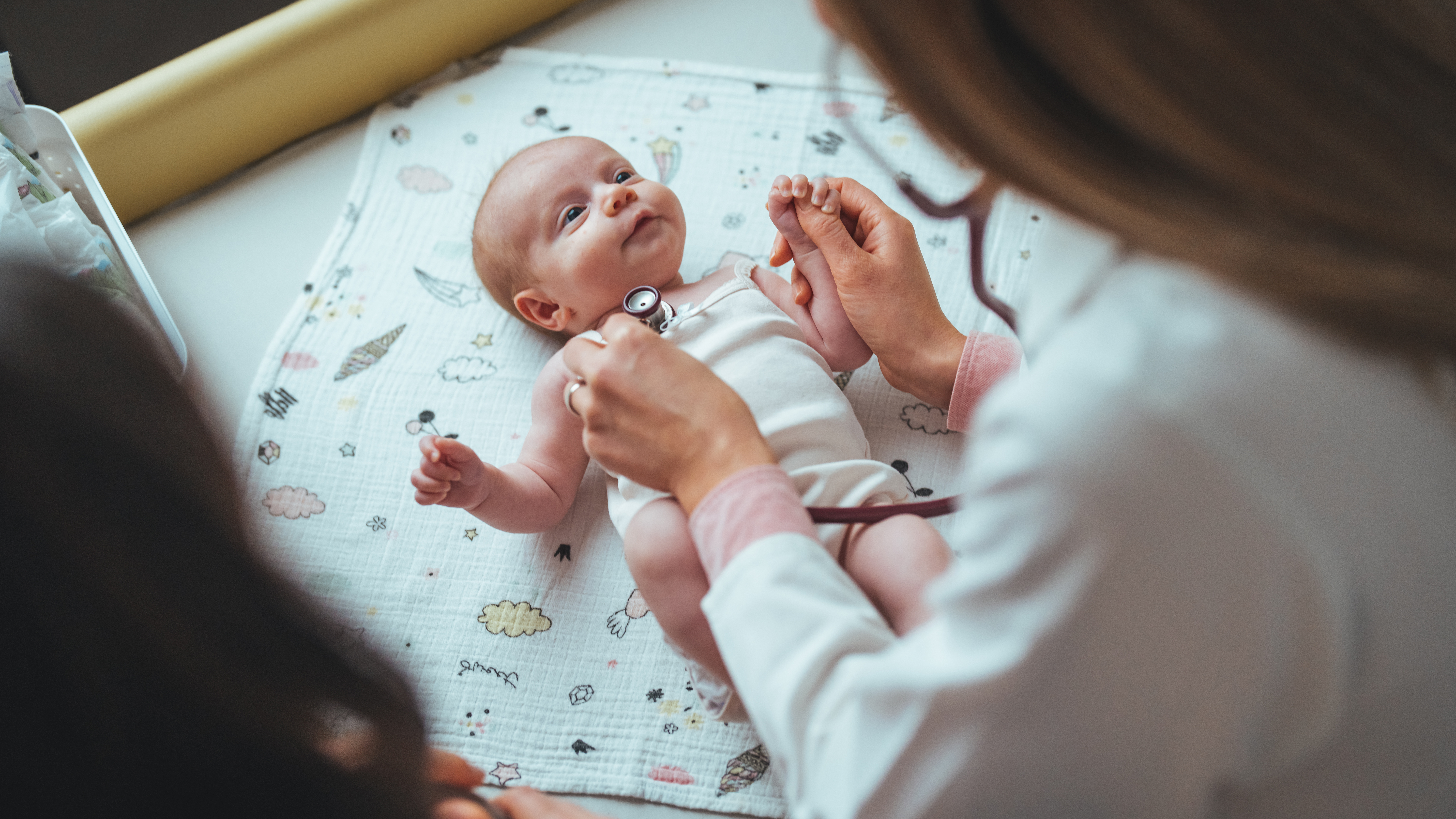 Doctor checking baby’s heart rate