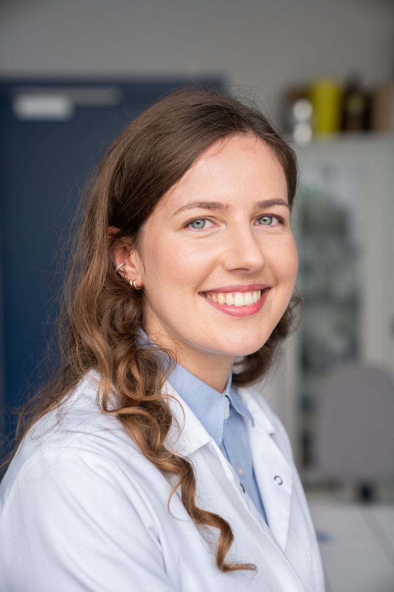 Female researcher smiling in lab.