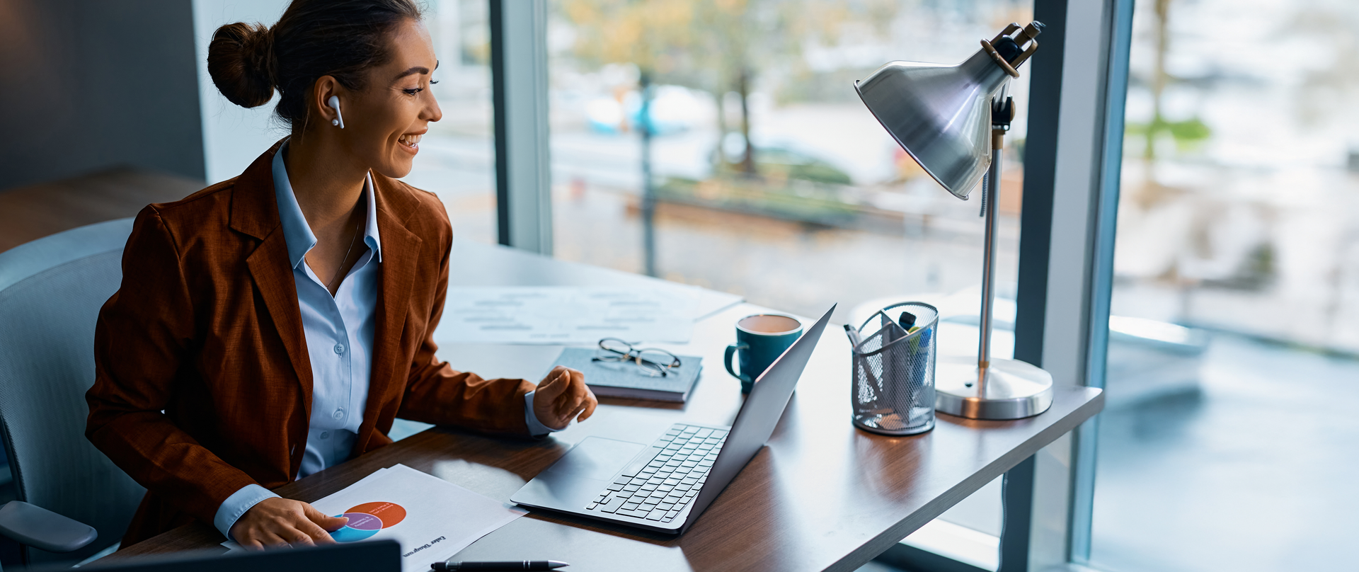 A remote sales representative on a video call with an HCP engaged in a productive conversation with visible medical charts or documents on the screen.