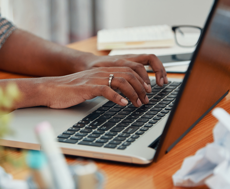 Business person using laptop in office