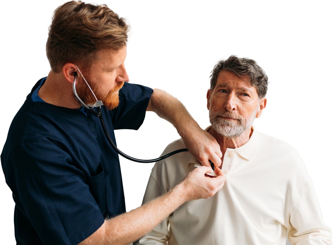 Healthcare professional using a stethoscope on an older man.