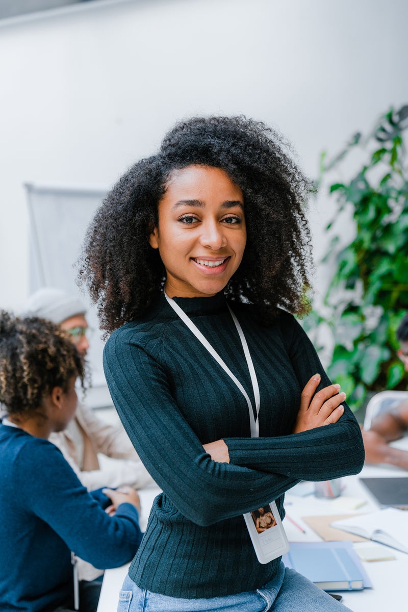 Woman standing and smiling in the office.