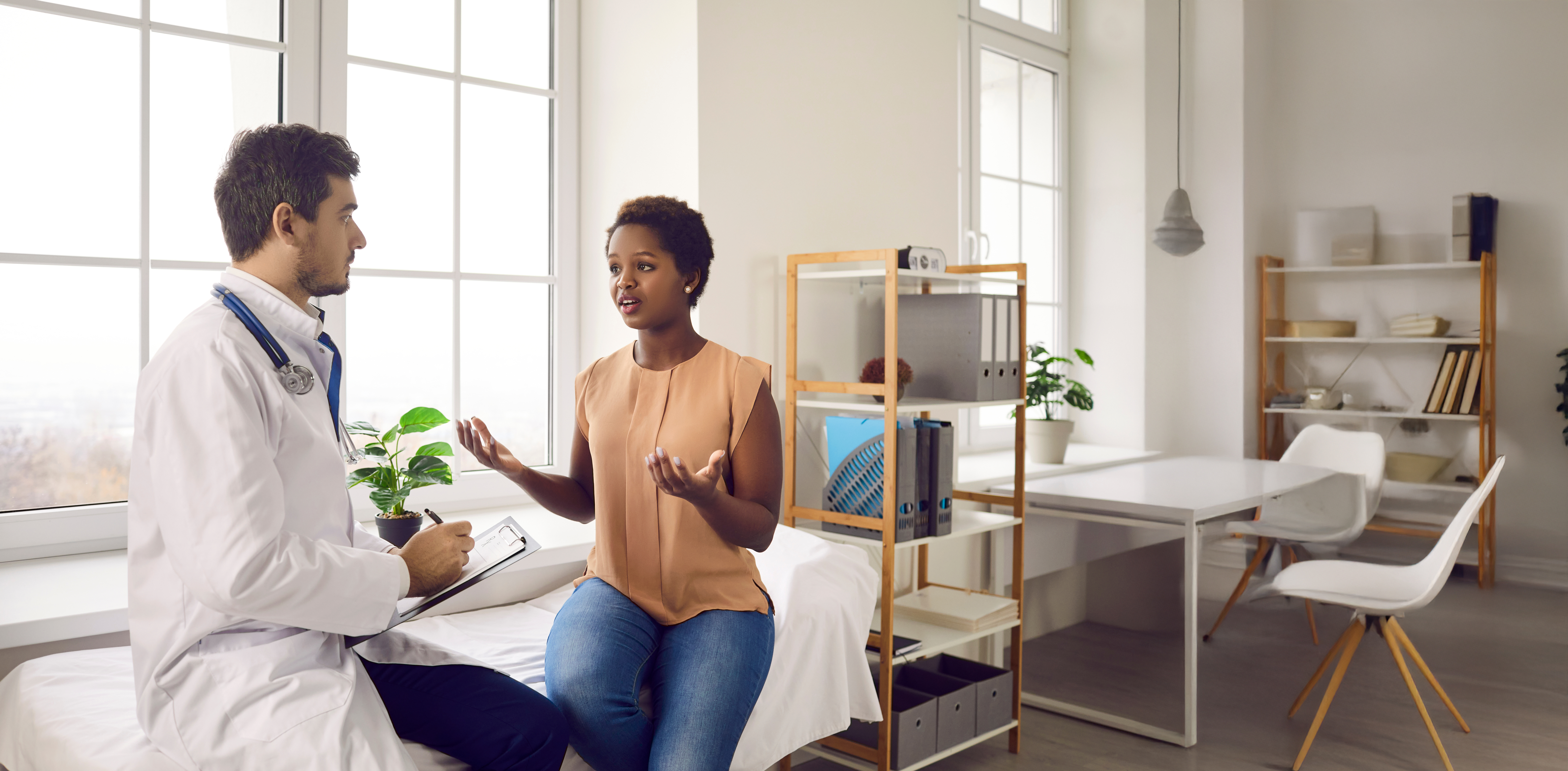 Healthcare provider talking with patient in exam room