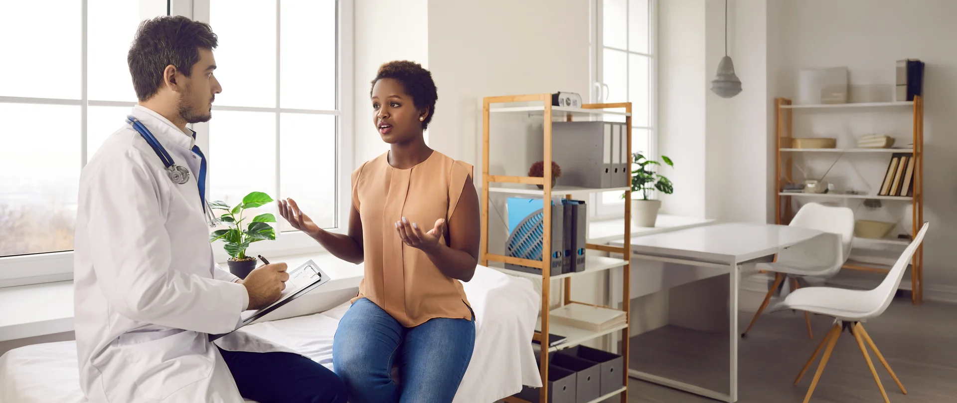 Healthcare provider talking with patient in exam room