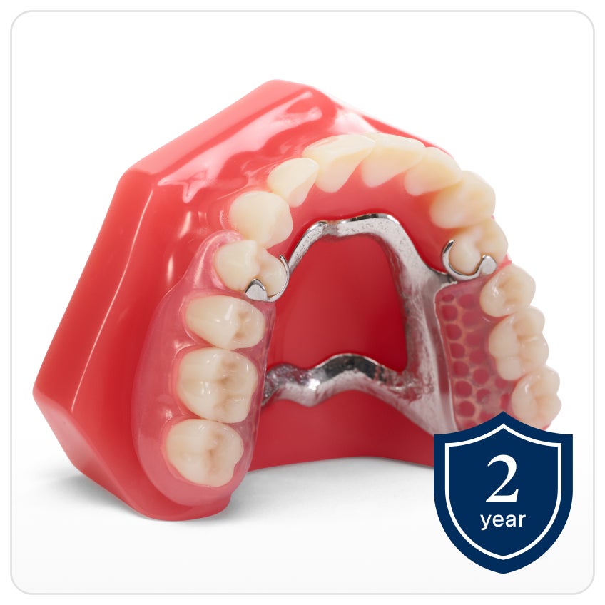 An upper denture model displaying Flexilytes Combo℠ partial dentures with a metal framework. A shield icon with text that reads "2 year" indicating the warranty.